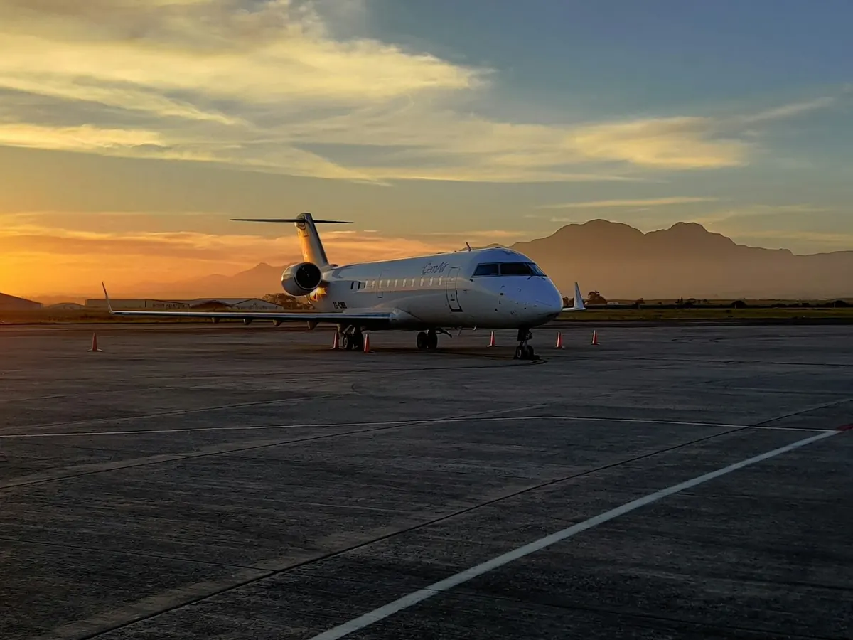 Light business jet on a desert ramp at sunset