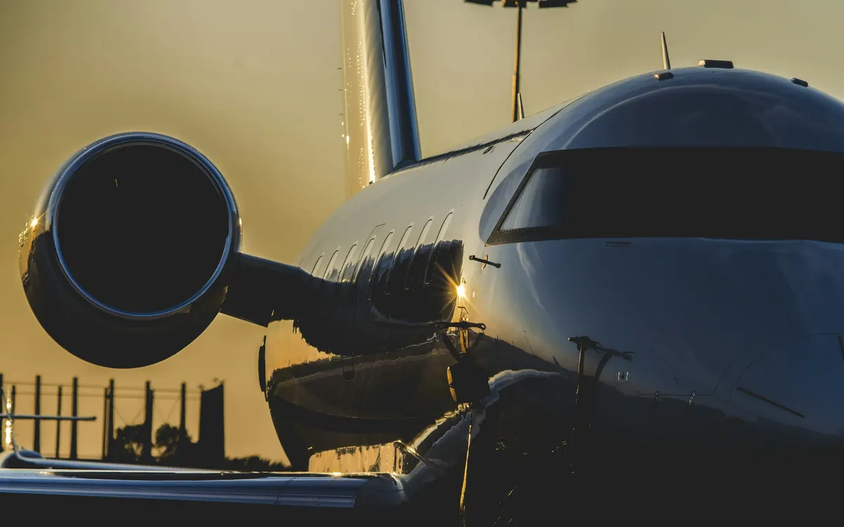 Late sun on the engine and cabin windows of a parked business jet